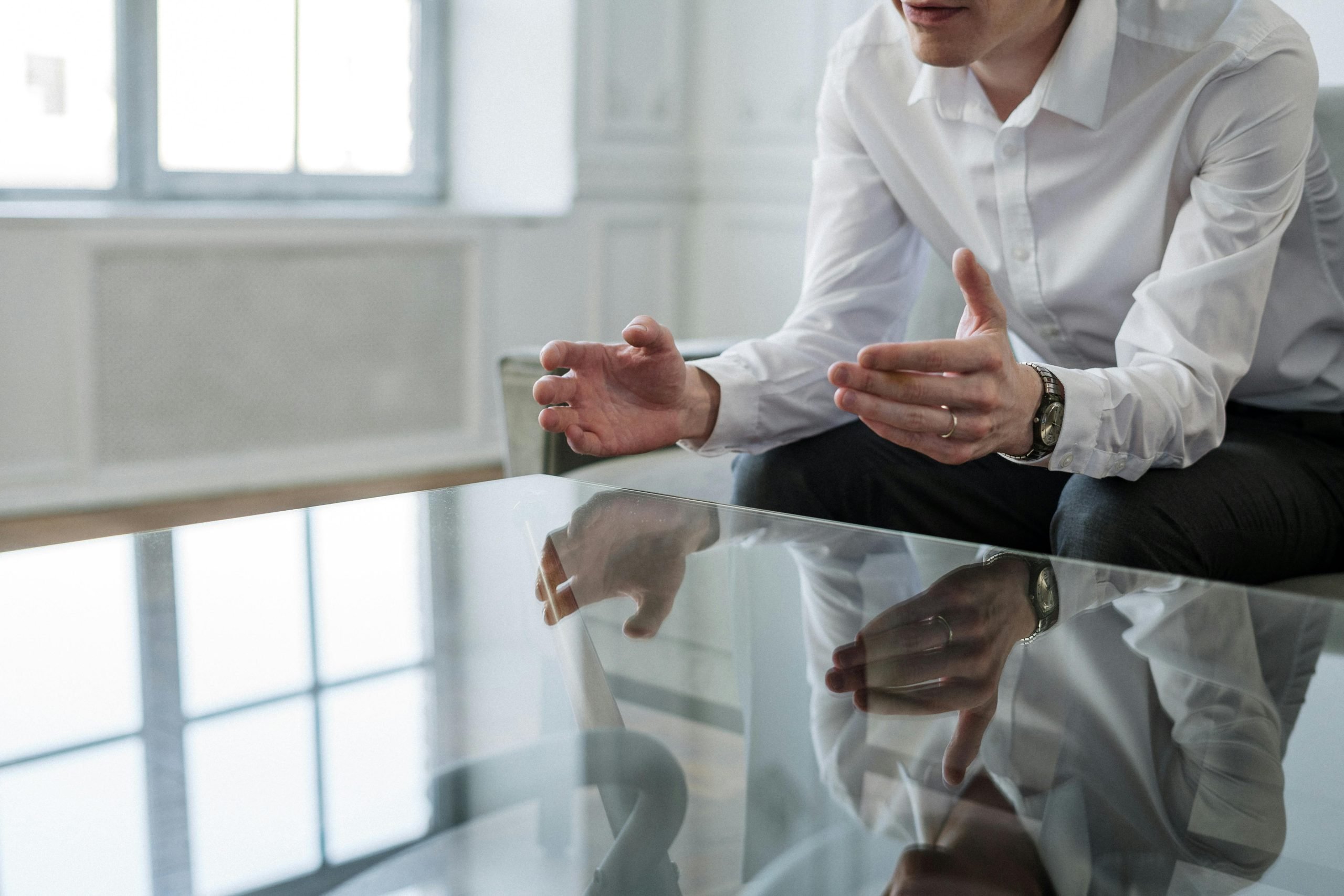 Photo of a therapy appointment, person with hand gesture representing window of tolerance